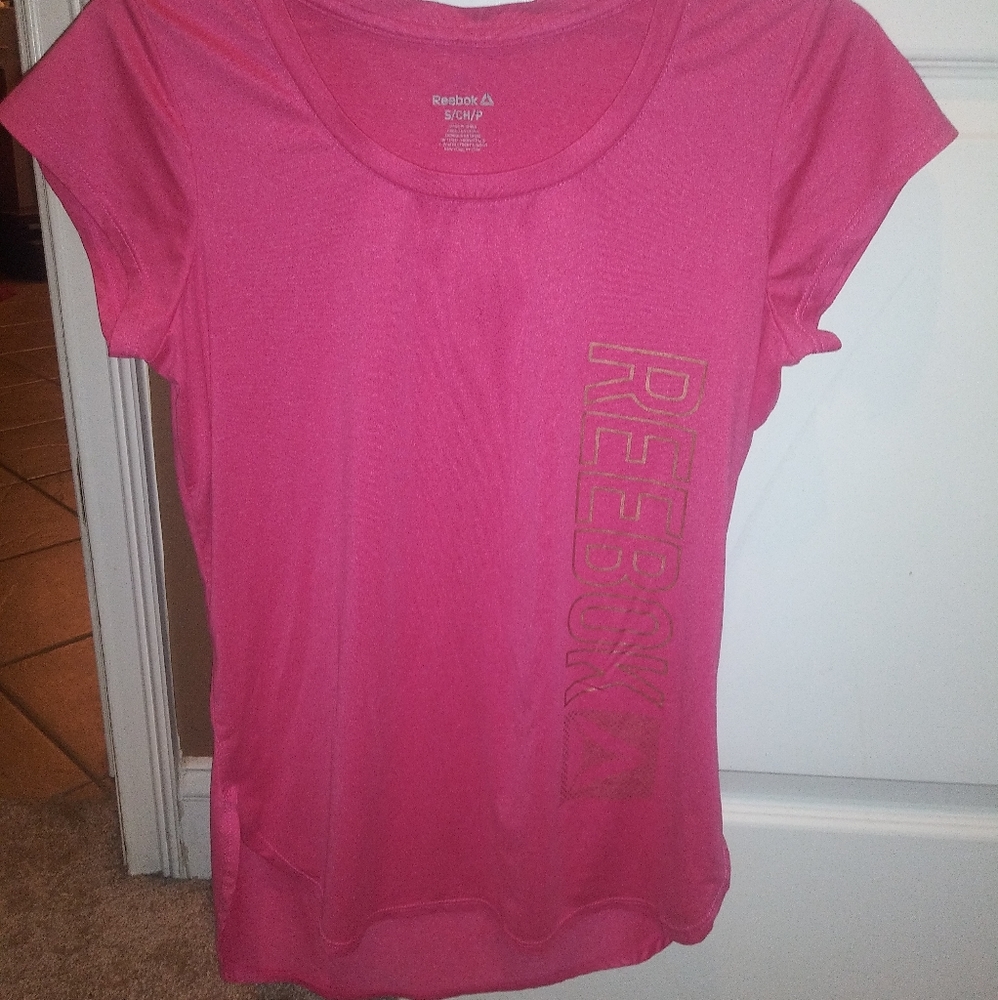 Reebok size S shirt with cute cutouts on the size.